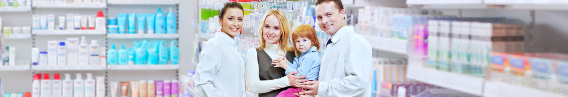 two pharmacists with woman and her daughter smiling